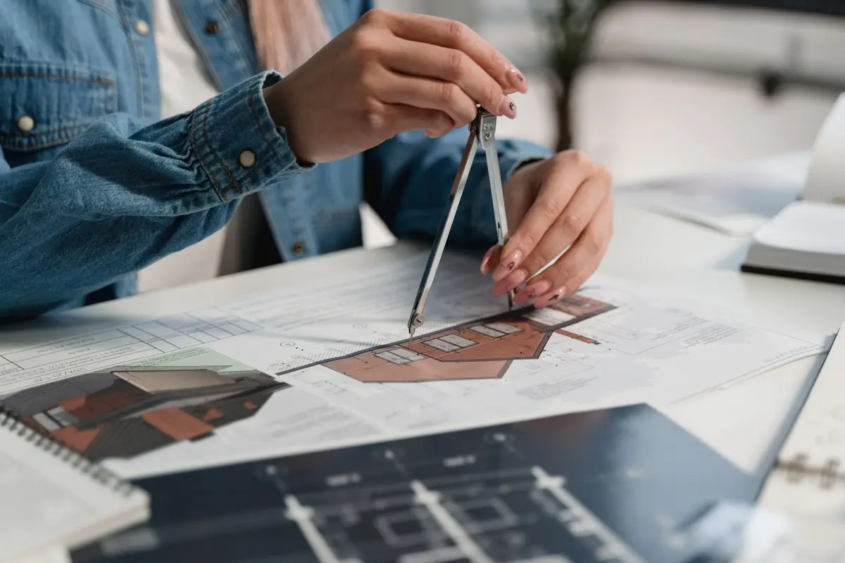 An architectural model and drawings on a table